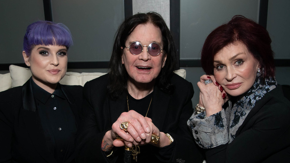 Sharon Osbourne sitting besides husband Ozzy Osbourne and daughter Kelly Osbourne