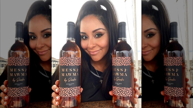 Nicole "Snooki" Polizzi posing with wine bottles