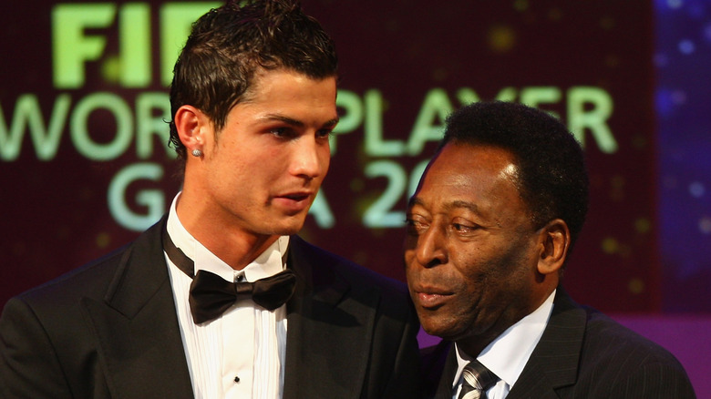 Pelé and Cristiano Ronaldo on stage, speaking