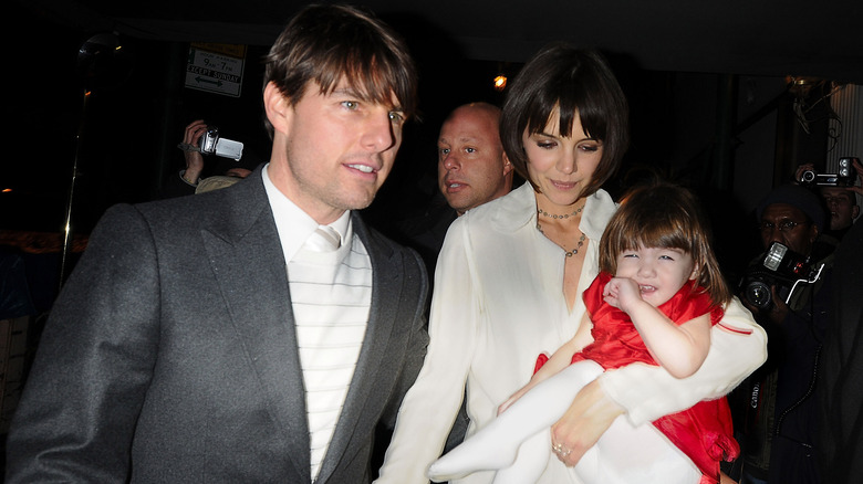 Tom Cruise with Katie Holmes holding Suri Cruise