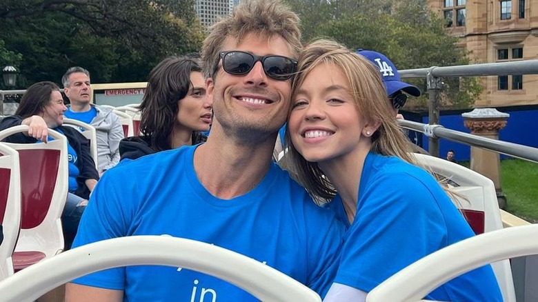 Sydney Sweeney, Glen Powell with heads pressed together