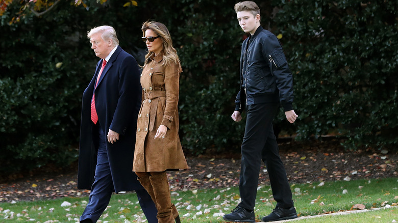 Barron Trump wearing a black bomber jacket