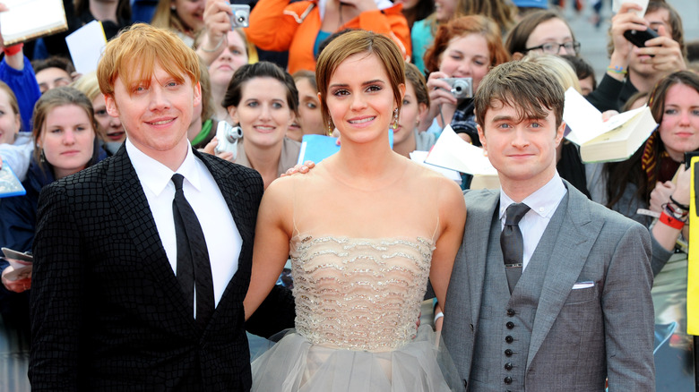 Daniel Radcliffe, Rupert Grint, and Emma Watson at a 2011 premiere