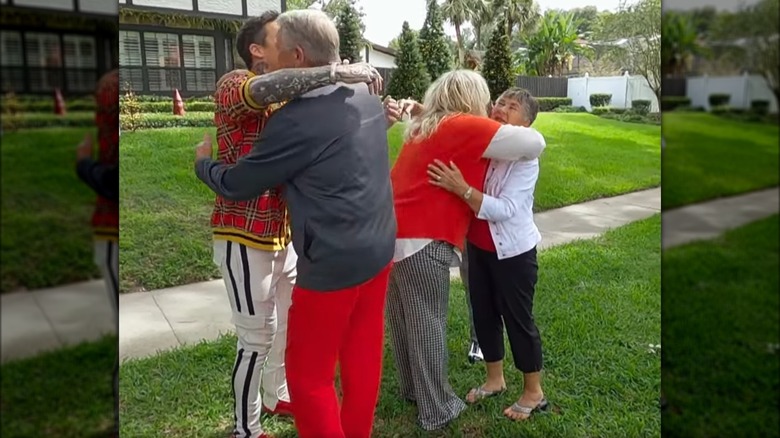 David Bromstad hugging his dad as his sister hugs their mom on "My Lottery Dream Home: Holiday Extravaganza."