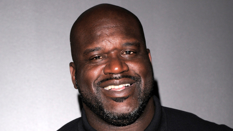 Shaquille O'Neal smiling in a polo