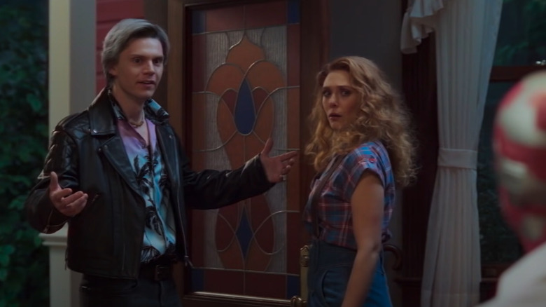 Evan Peters with arms out, Elizabeth Olsen looking back