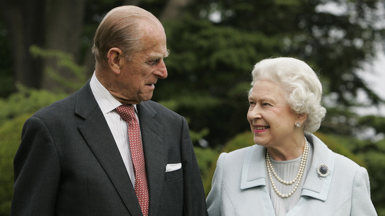 Prince Philip and Queen Elizabeth II looking at one another