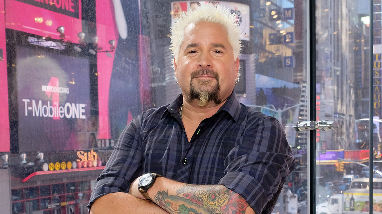 Guy Fieri looking at camera with his arms crossed