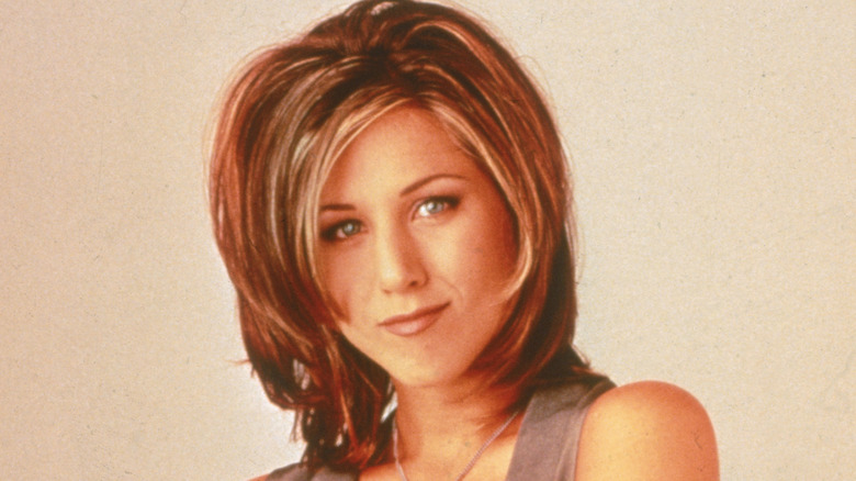 Jennifer Aniston posing with The Rachel haircut