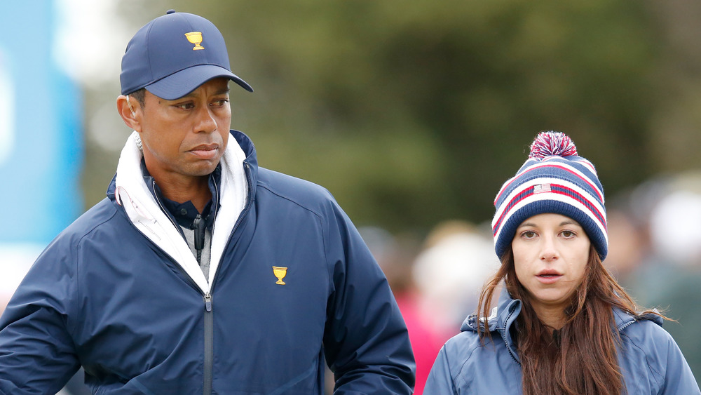 Tiger Woods and Erica Herman walk on a golf course together