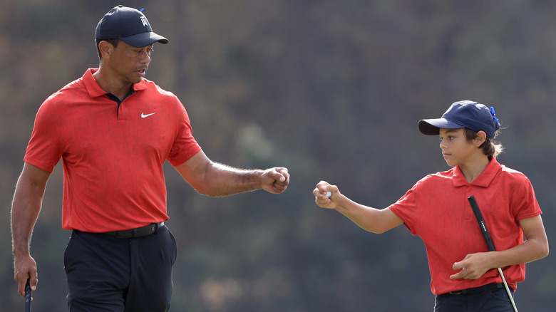 Tiger Woods and Charlie Woods fist bump at the PNC Championship
