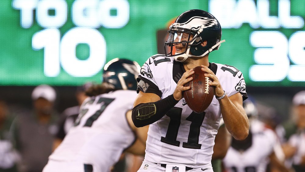 Tim Tebow about to throw a football in a Philadelphia Eagles uniform