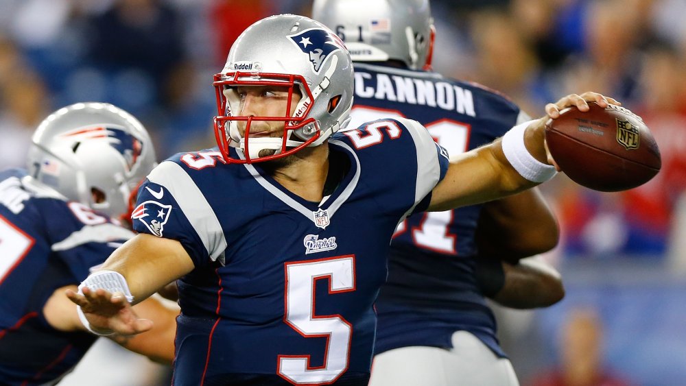 Tim Tebow winding up to throw a football for the New England Patriots