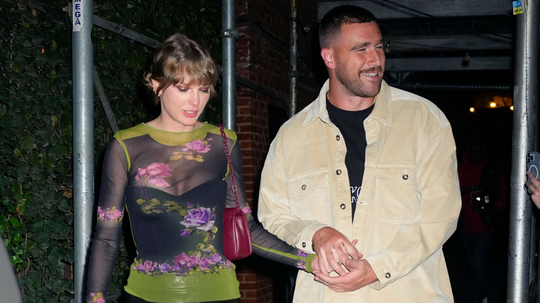 Travis Kelce and Taylor Swift holding hands