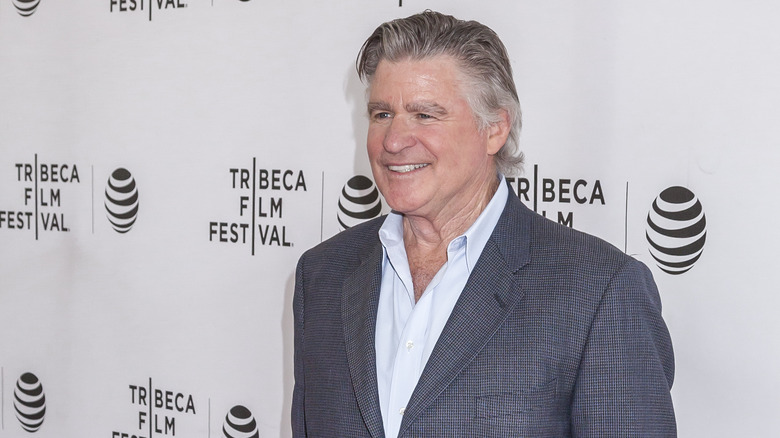 Treat Williams smiling in gray
