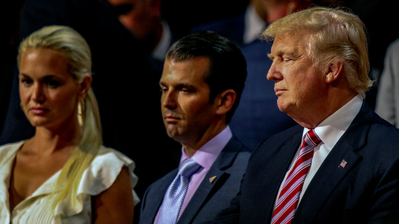 Vanessa, Don Jr., and Donald Trump looking solemn