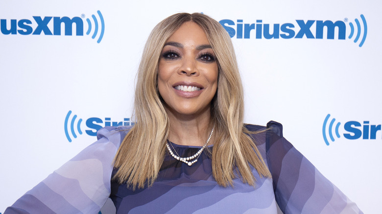 Wendy Williams poses in purple dress