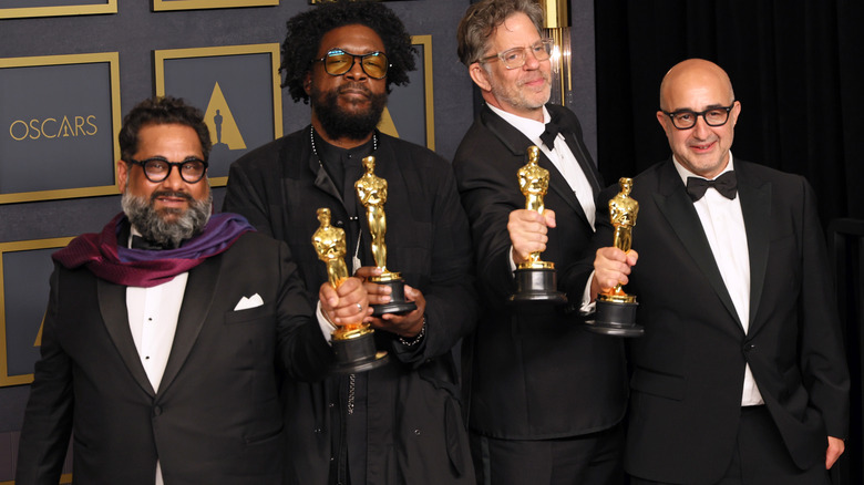 Questlove and producing partners posing with awards