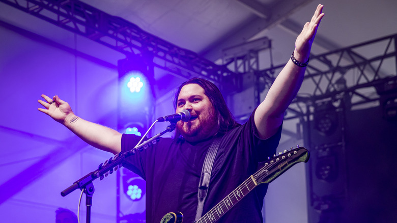 Wolfgang Van Halen raises his arms onstage