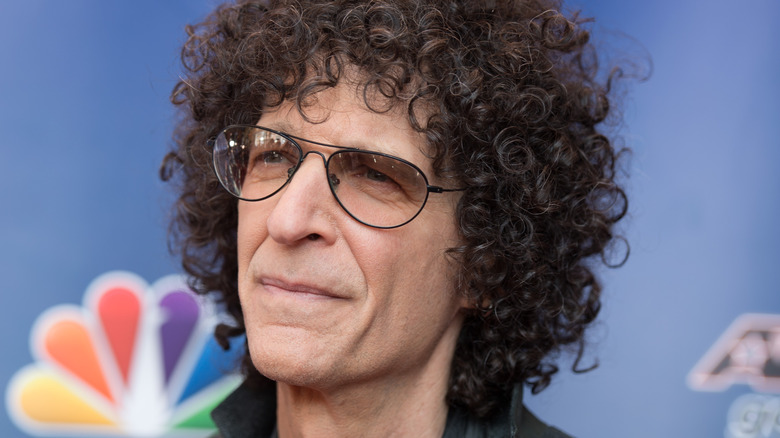 Howard Stern grimacing wearing glasses