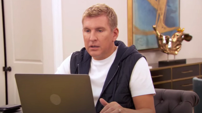 Todd Chrisley looking at laptop