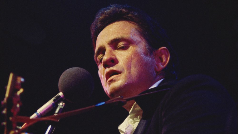 Johnny Cash singing and playing guitar