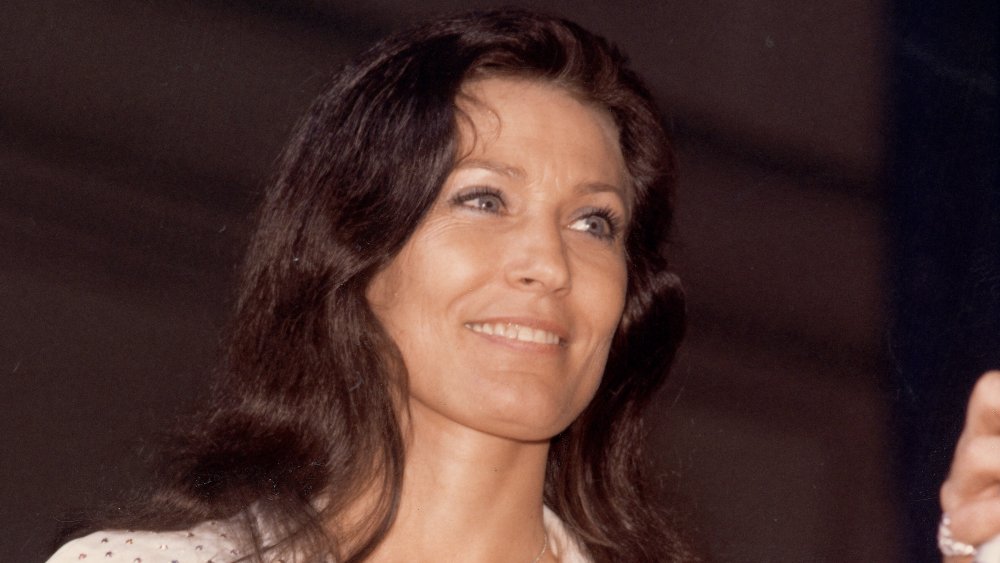 Loretta Lynn smiling and looking off to the side