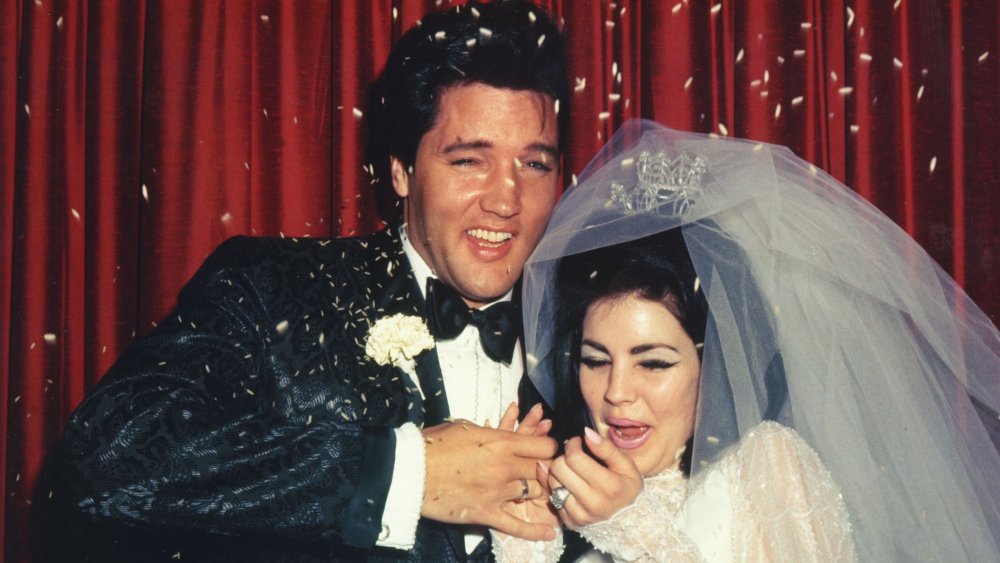 Elvis Presley and Priscilla Presley have rice thrown at them on their wedding day