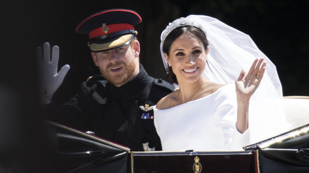 Prince Harry and Meghan Markle in a carriage on their wedding day in 2018