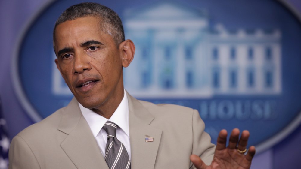 Barack Obama speaking, hand raised