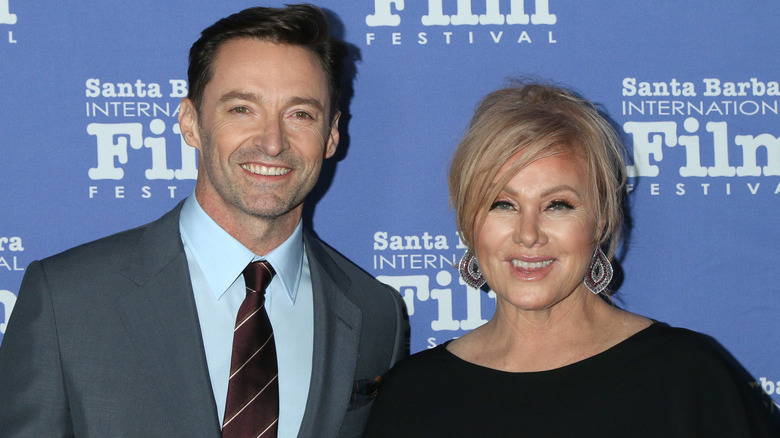 Hugh Jackman smiles alongside wife Deborra-Lee Furness on the red carpet