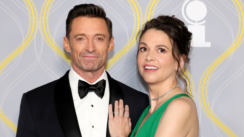 Hugh Jackman wearing a black tuxedo and bow tie with Sutton Foster wearing a green strapless gown