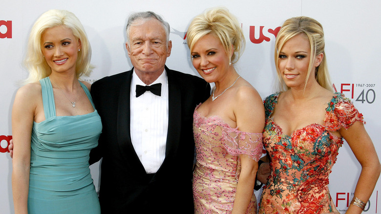 Holly Madison, Hugh Hefner, Bridget Marquardt, and Kendra Wilkinson smiling together