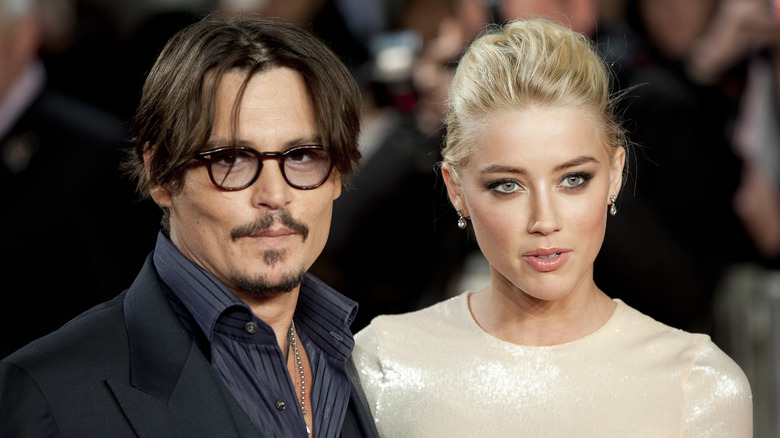 Johnny Depp black glasses smiling Amber Heard gold dress