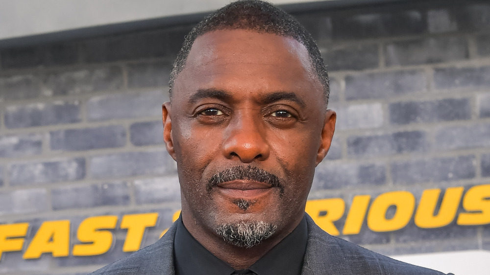 Idris Elba smiling slightly