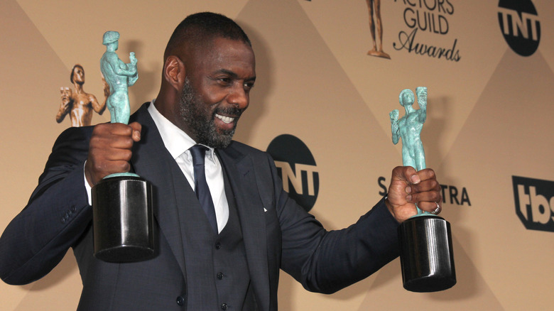 Idris Elba holding two SAG awards