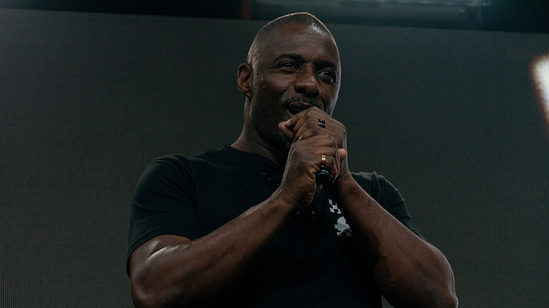 Idris Elba on stage with microphone