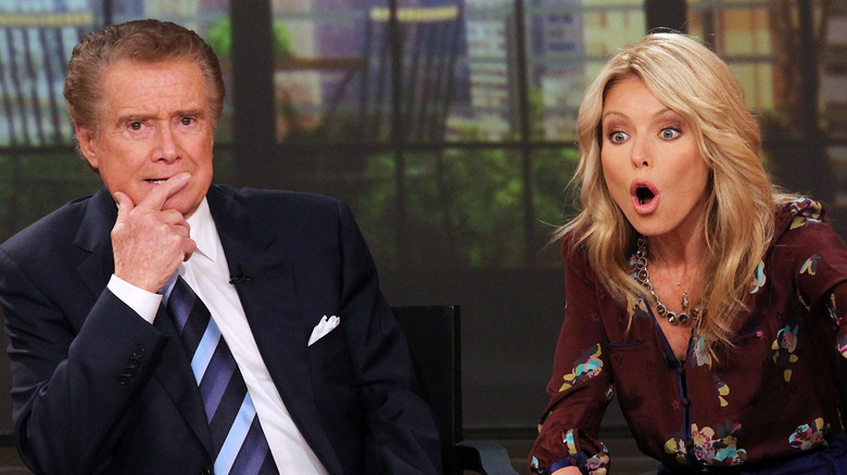 Kelly Ripa looking shocked beside Regis Philbin