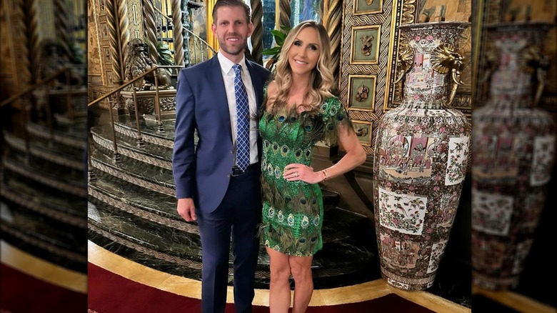 Lara Trump standing next to Eric Trump in green peacock dress