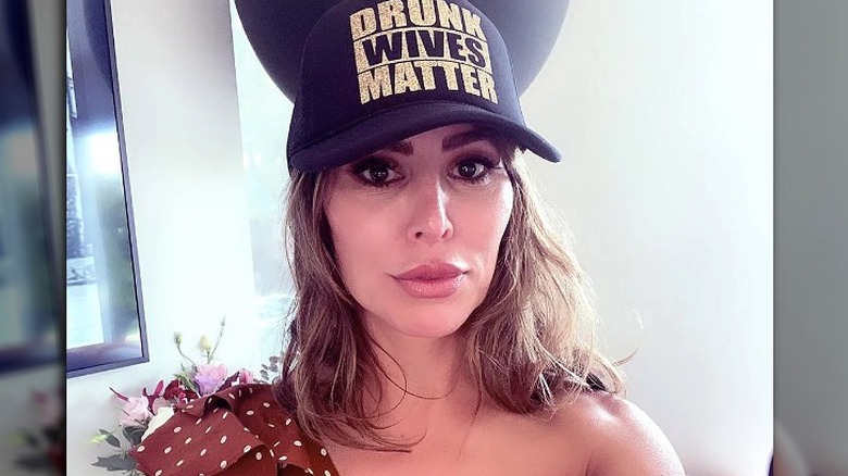 Kelly Dodd wearing her "Drunk Wives Matter" hat