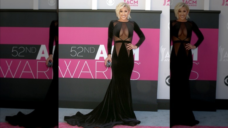 Savannah Chrisley wearing black dress with sheer panels