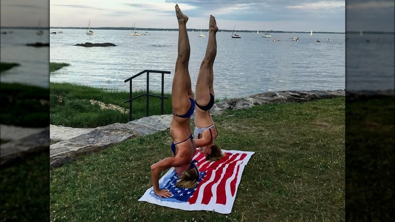 Kira Stokes, Candace Cameron Bure doing headstands