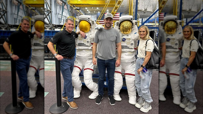 Mike Fisher, Carrie Underwood posing with astronaut suits