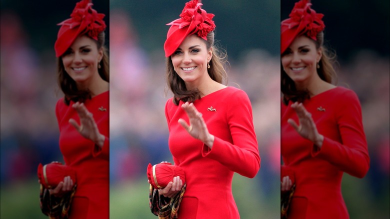 Kate Middleton wearing a red dress and a red hat