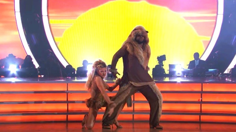 Wanya Morris and Lindsay Arnold in lion costumes