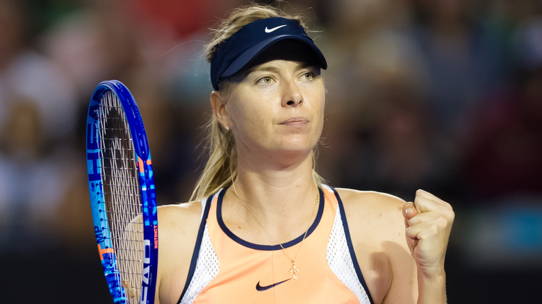 Maria Sharapova holding tennis racket