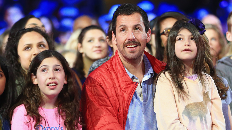 Sadie, Adam, and Sunny Sandler looking up from the audience