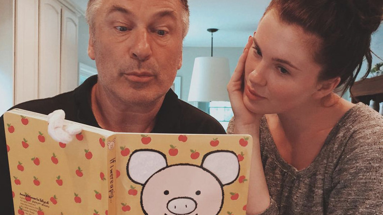 Alec Baldwin and Ireland Baldwin reading a book