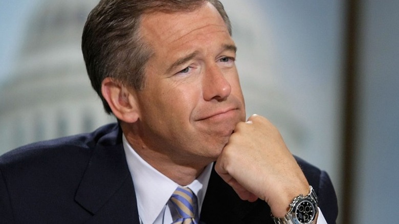 Brian Williams smiling with his chin on his hand