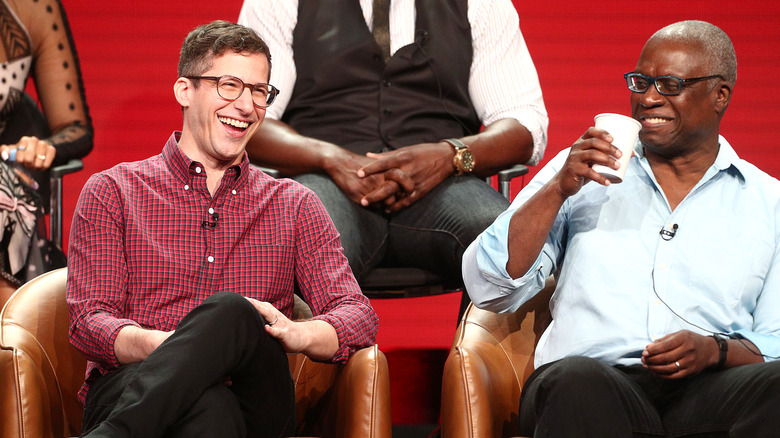 Andy Samberg and Andre Braugher laughing